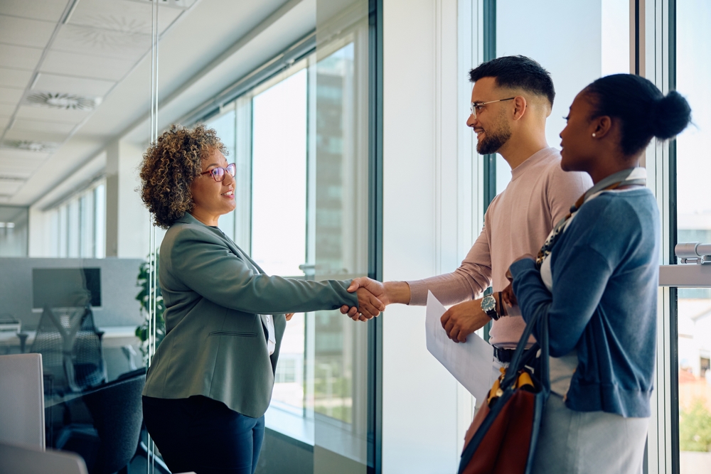 Young,Couple,Shaking,Hands,With,Their,Financial,Advisor,After,Successful